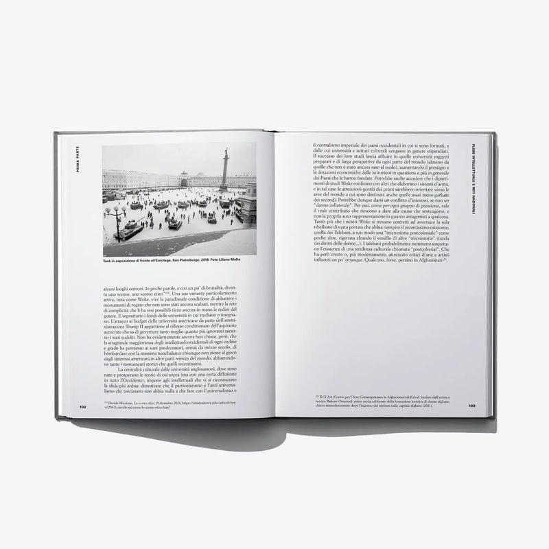 Open hardcover art book with photo of a city scene and printed paragraphs