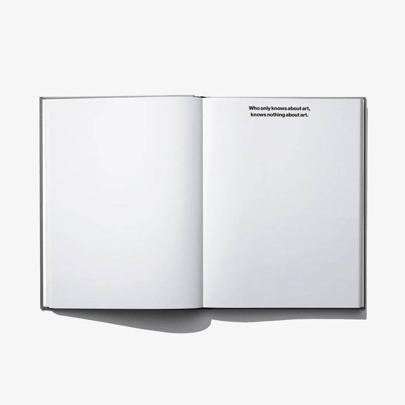 Open hardcover book with blank left page and small paragraph on right page