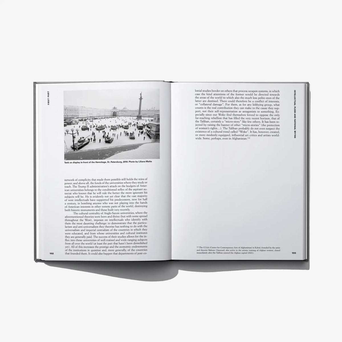 Open hardcover book with small landscape photo on left and text-filled right page