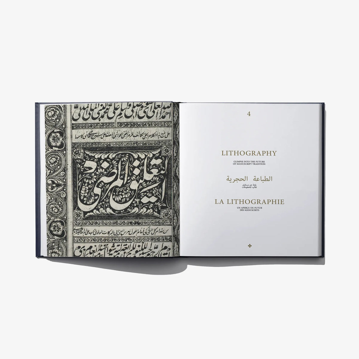 Open book spread featuring black-and-white calligraphy lithography on the left page.