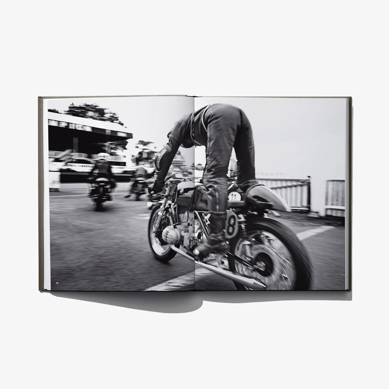Photo book spread of a rider on a classic motorcycle on a track