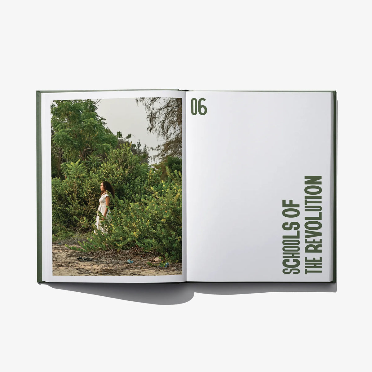 Opened hardcover book with landscape photo and bold vertical heading on the right page