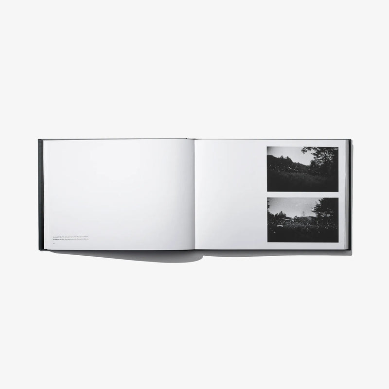 Open photo book spread with blank left page and two landscape photo panels