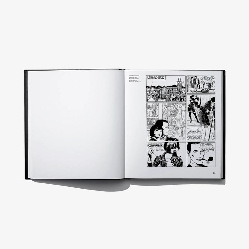 Hardcover art book open, left blank page, right black-and-white comic panels
