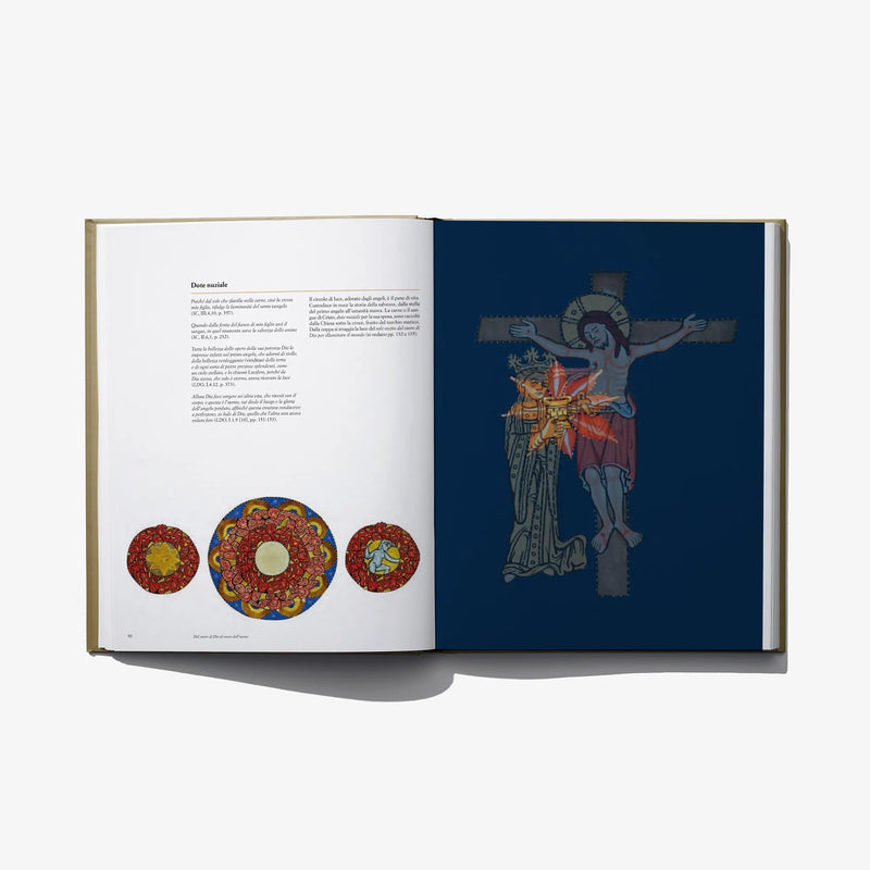 Open hardcover book with colorful circular artworks on left and robed figure on right