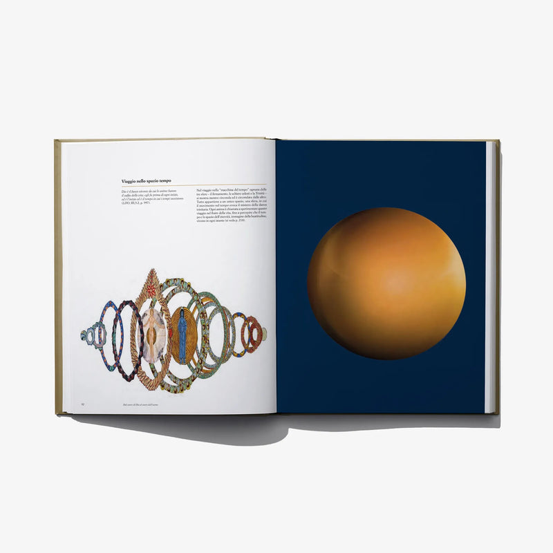 Open hardcover book with bead-like diagram on left and gold sphere image on right