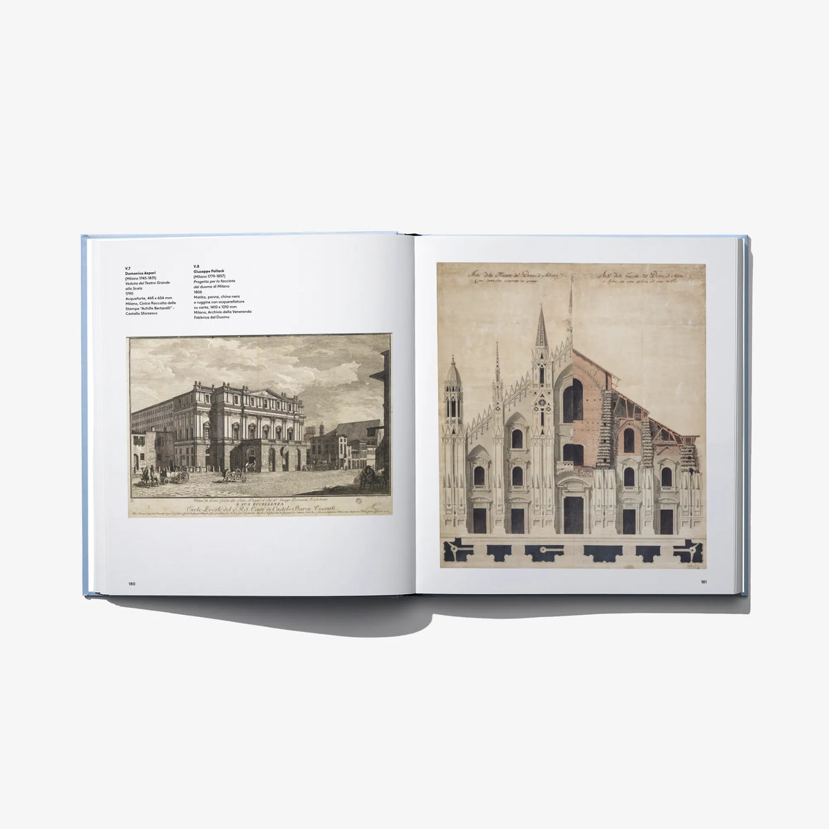 Open art book spread with architectural sketches and handwritten text blocks