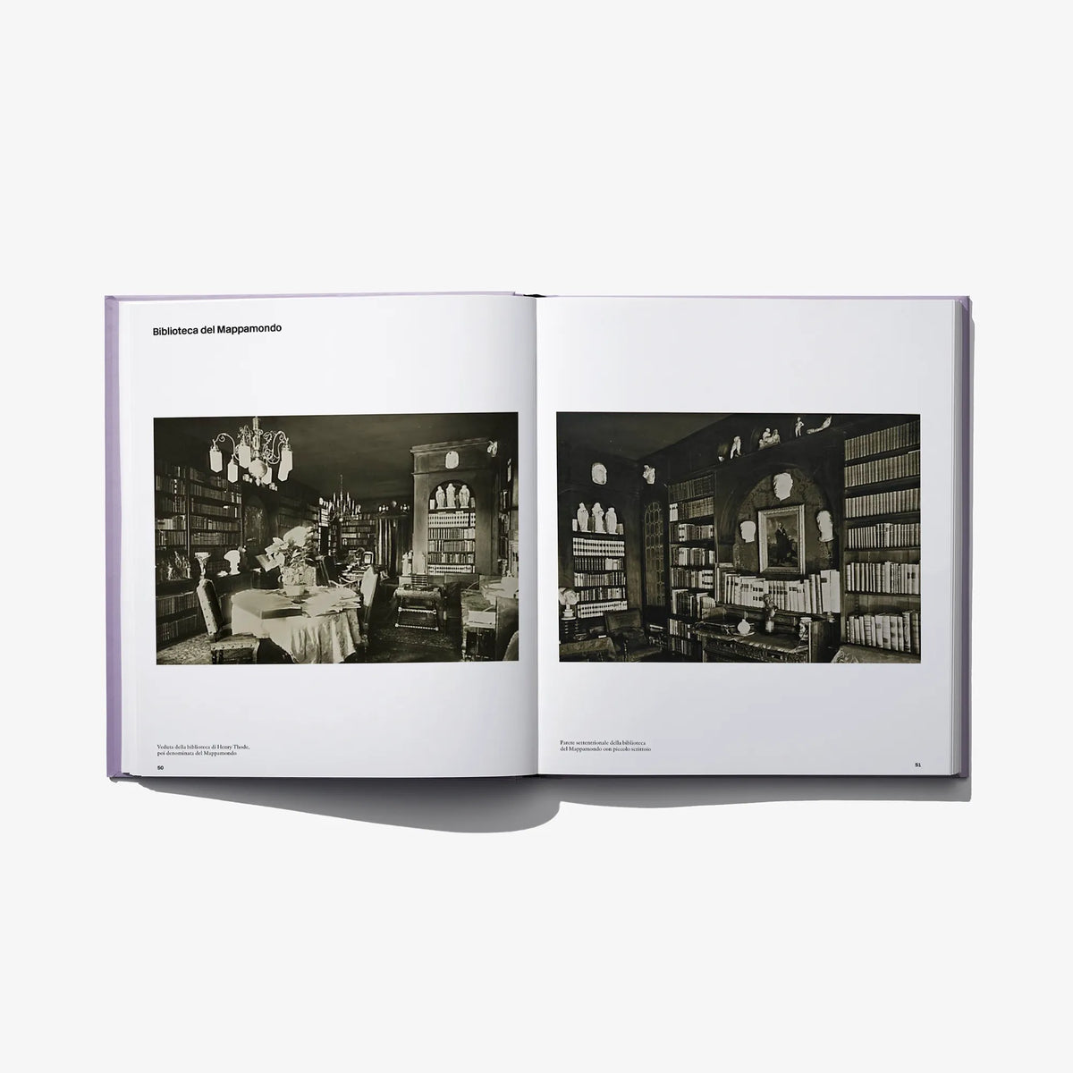 Opened photo book spread with two black-and-white interior photographs and captions