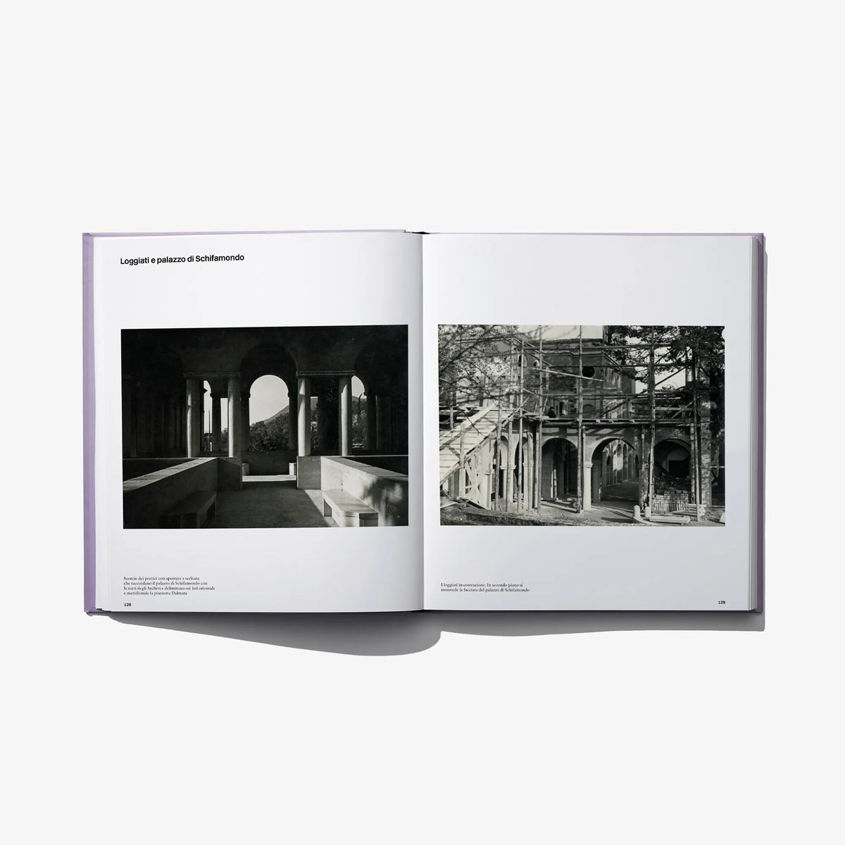 Opened photo book spread with two black-and-white archway photographs and captions