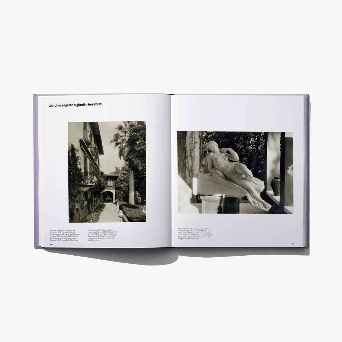Opened photo book spread with garden and sculpture black-and-white photographs and captions