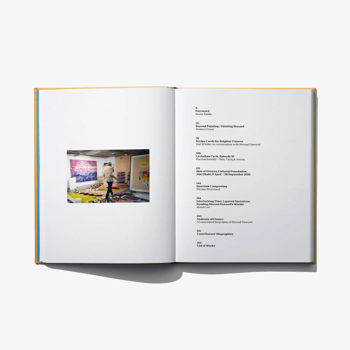 Open art book spread with printed text and a small color artwork photo
