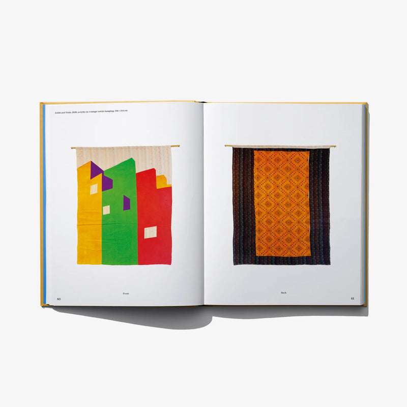 Open art book spread with two framed abstract artworks in orange and green