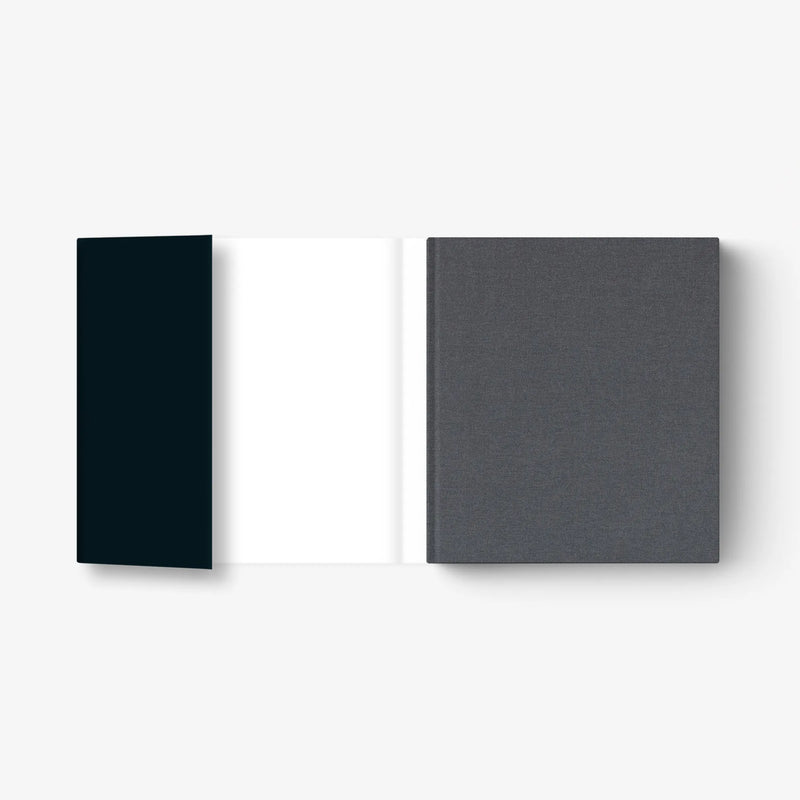 Hardcover art book with dark blue spine and textured gray back cover