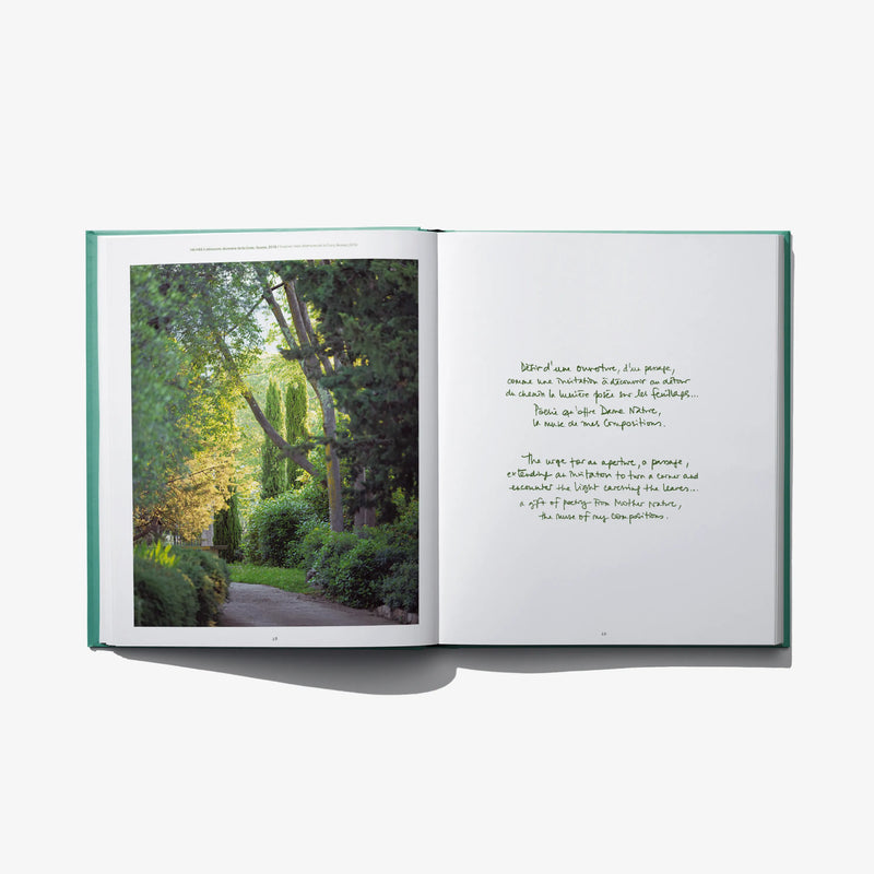 Open landscape design book with garden photo left page and handwritten text on right
