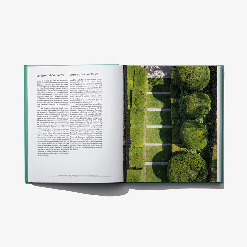Open landscape design book with printed text left page and hedge garden photo right