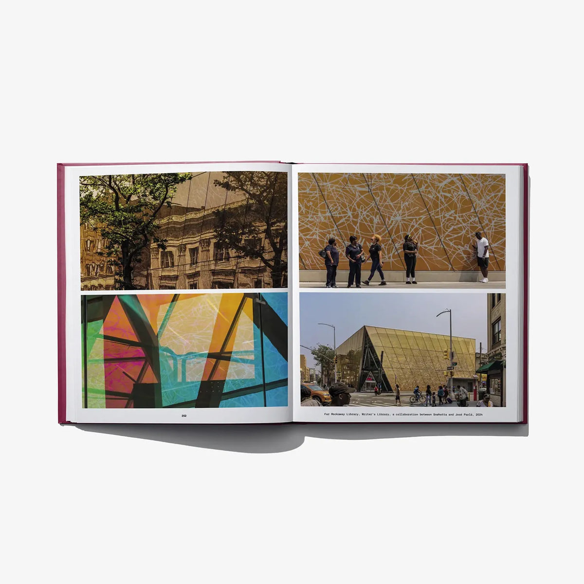 Open hardcover art book with four-panel city and mural images