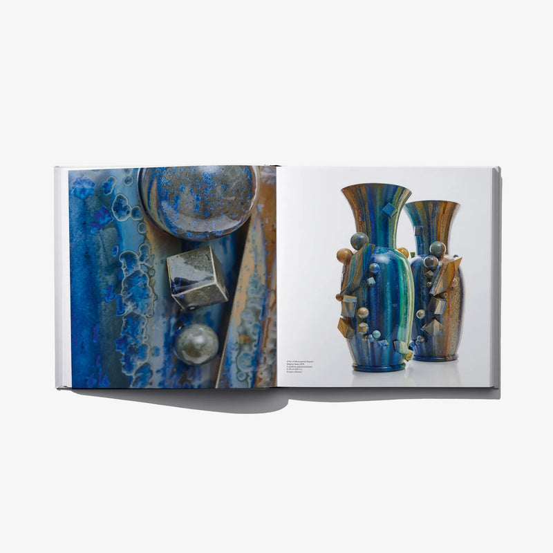 Open art book spread with blue ceramic vessels and close-up sculpture detail