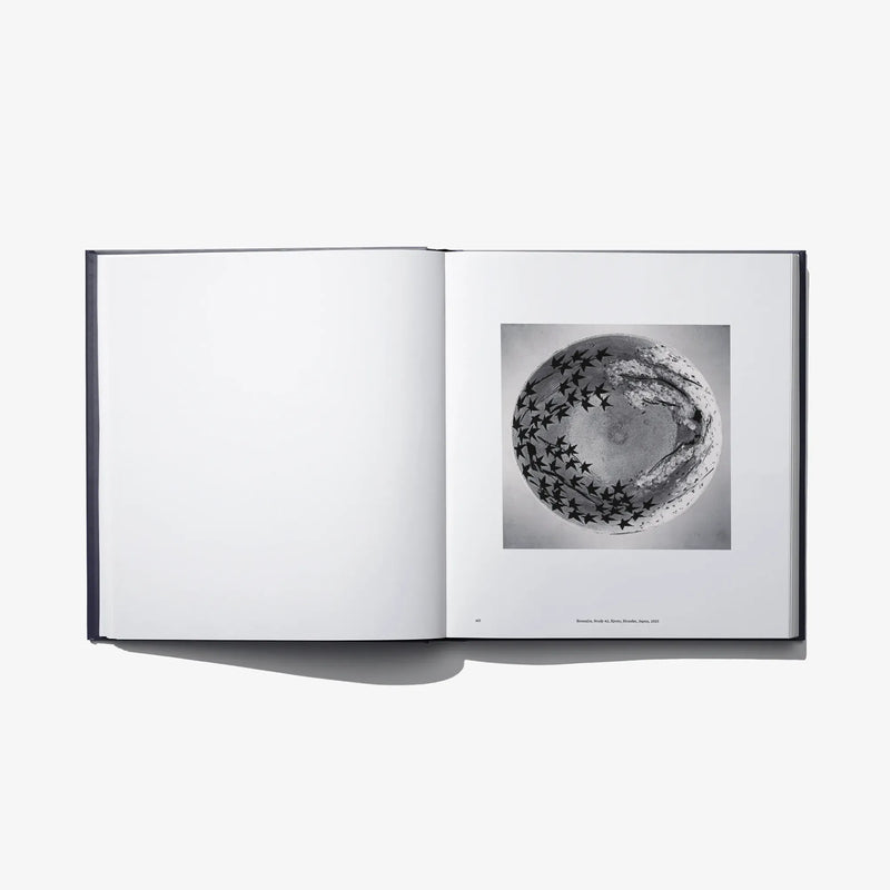 Open book “Constellation” with a black-and-white star pattern globe photo on right page.