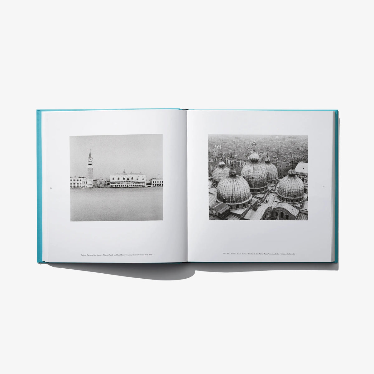 Open photo book spread with two black-and-white Venice views on left and right.