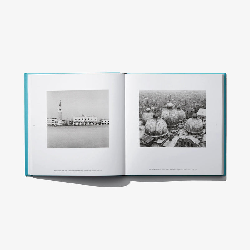 Open photo book spread with two black-and-white Venice views on left and right.