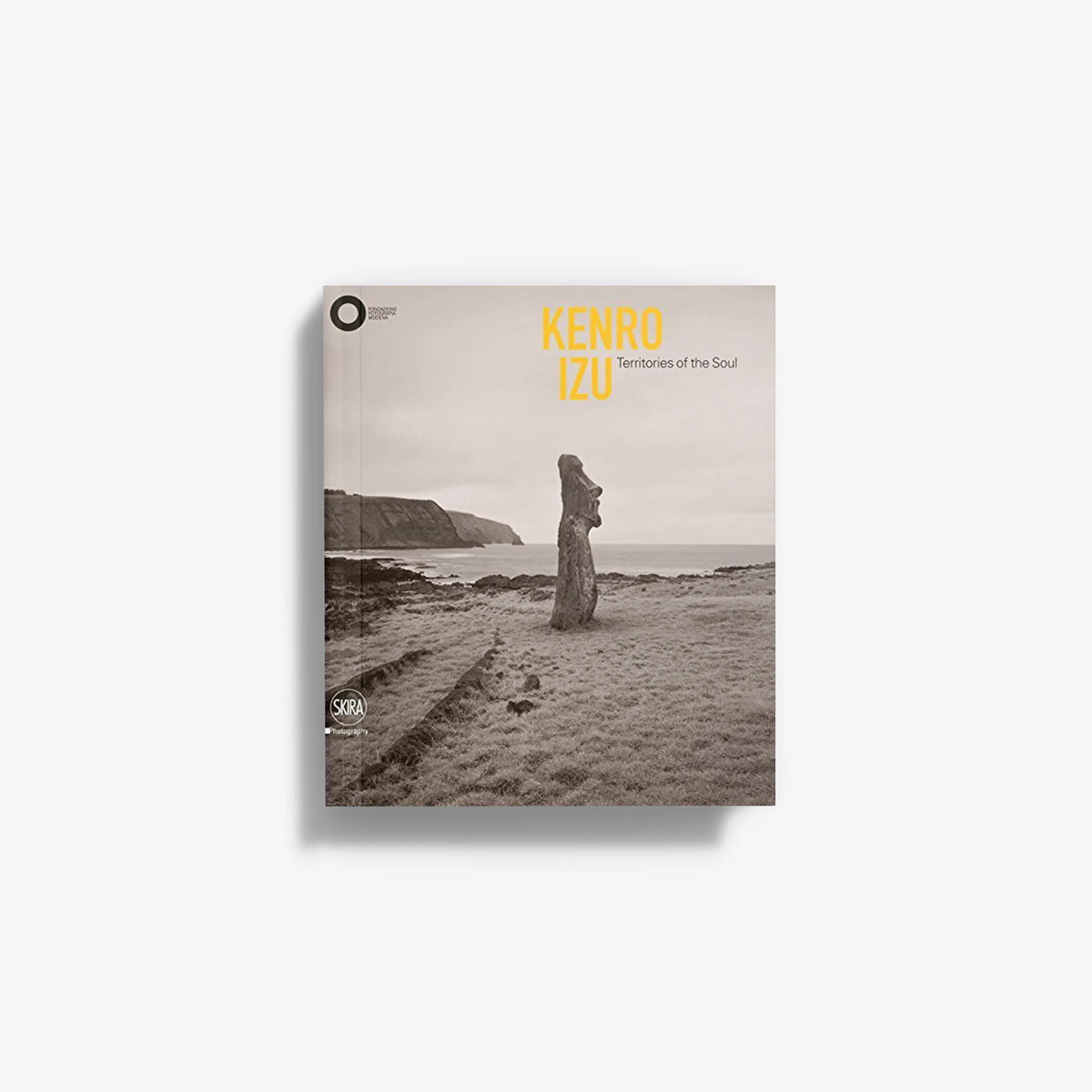 Photo book cover with sepia beach landscape, standing figure, and title text: Kenro Izu
