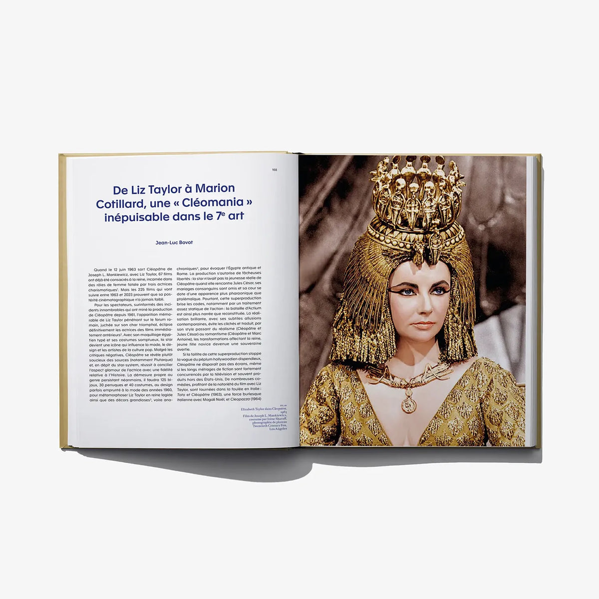 Open art book spread featuring a painted Cleopatra portrait with ornate gold headdress