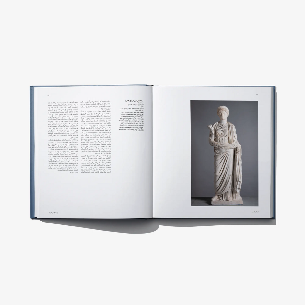 Open art book spread with a marble statue photo and Arabic text on the left page