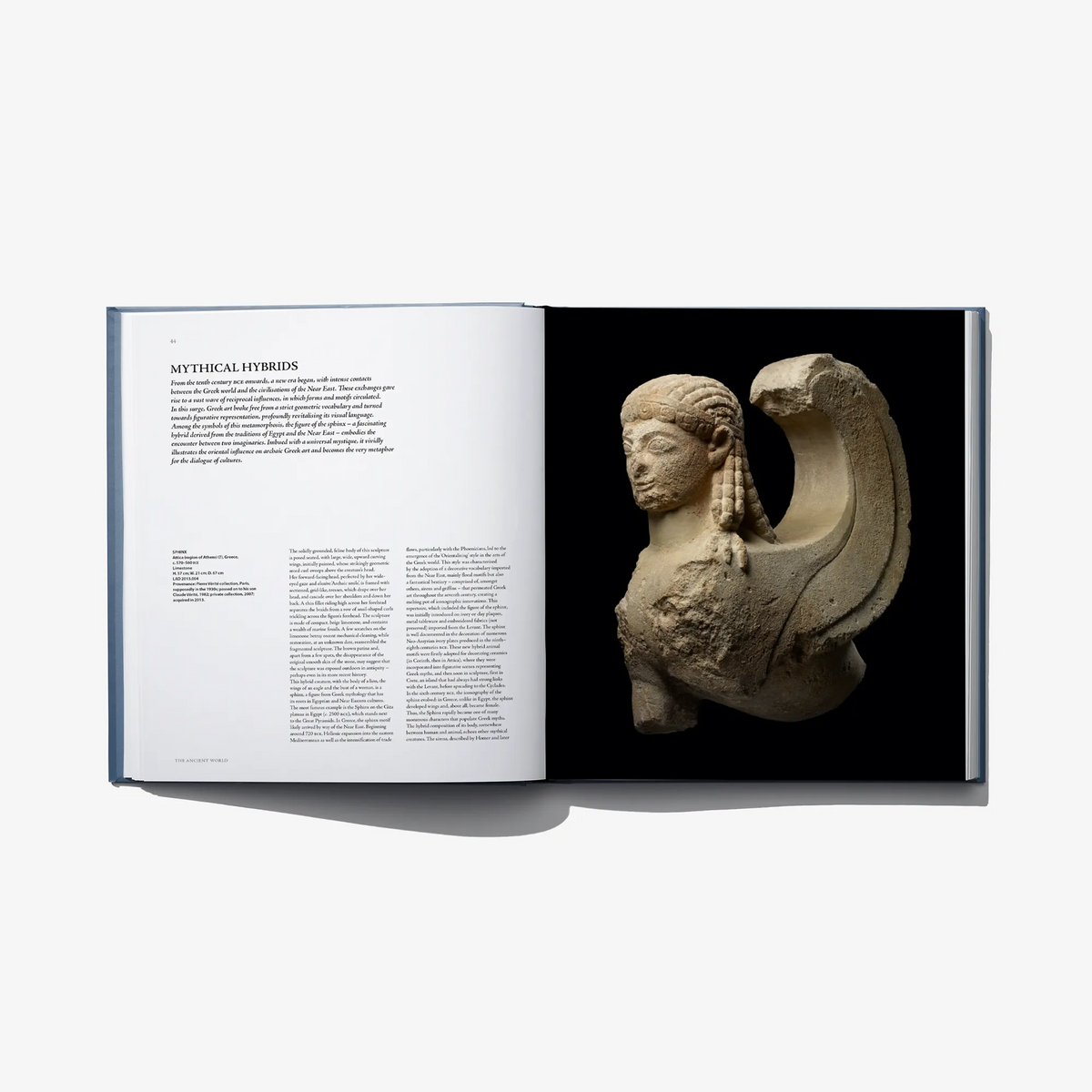 Open art book spread with a carved stone mythical figure on right page