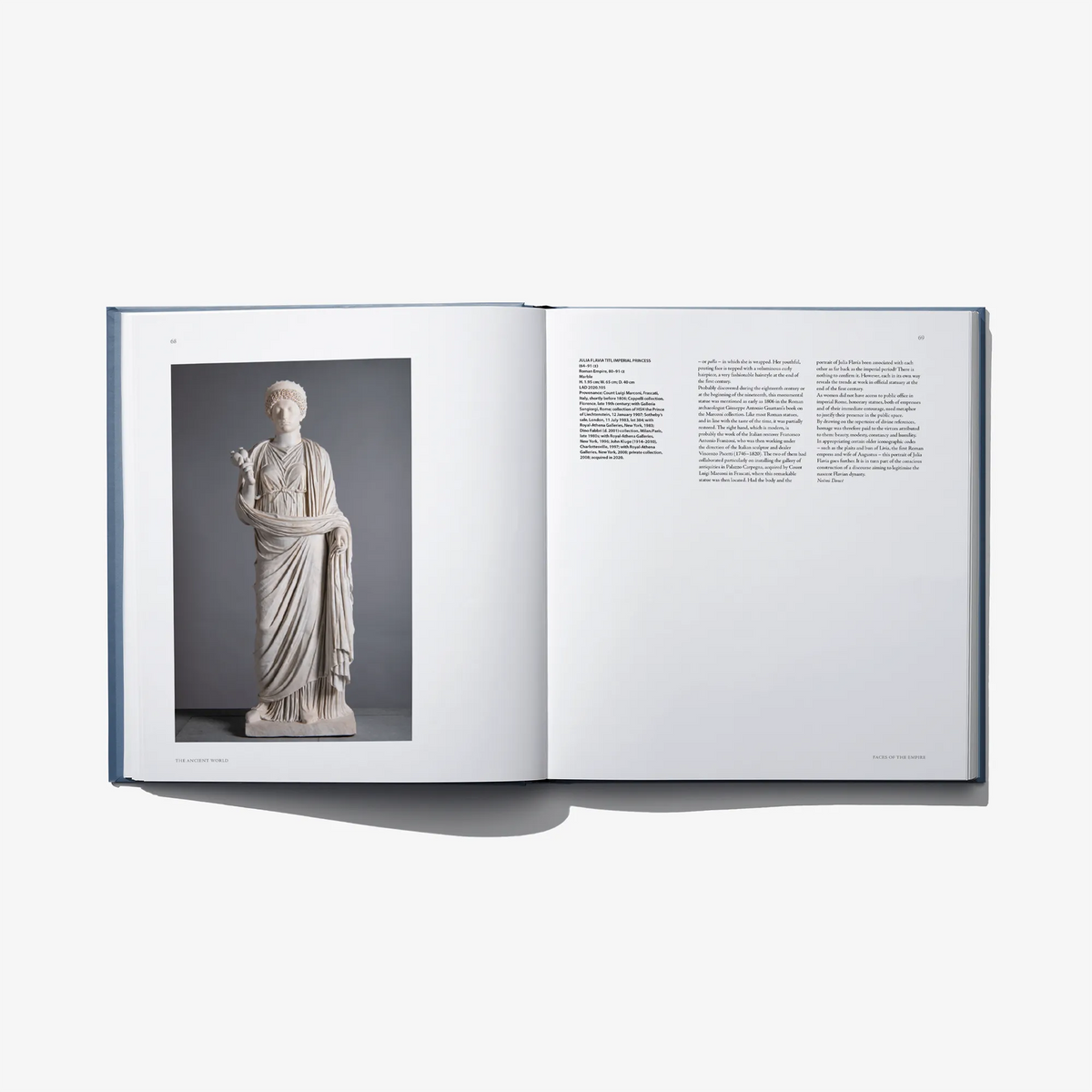 Open art book spread with a grayscale statue photo on left page