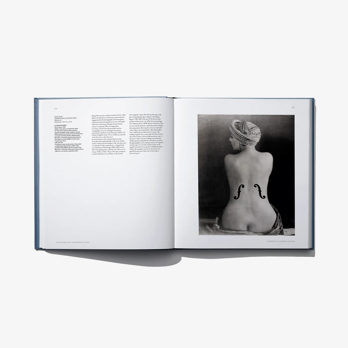Open art book spread with black-and-white sculpture photo on right page