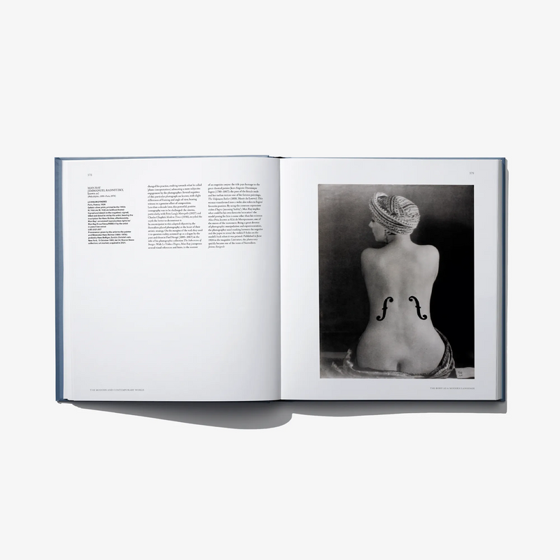 Open art book spread with black-and-white sculpture photo on right page