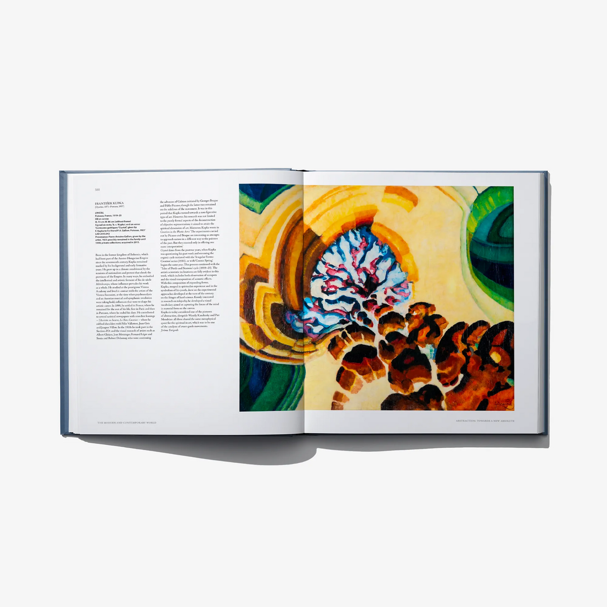 Open art book spread with a colorful artwork on right and text on left