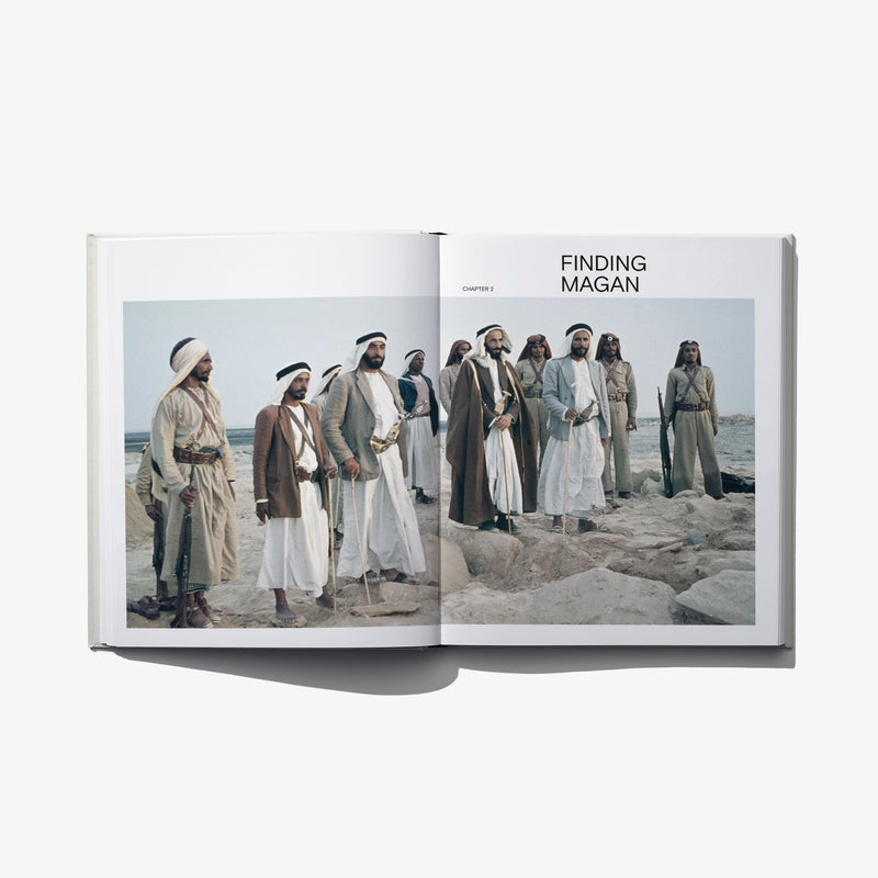 Open book spread with FINDING MAGAN header and group of men in robes on sand