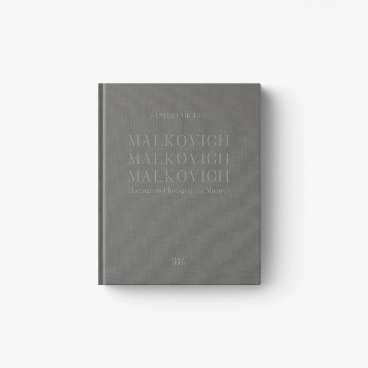 Gray hardcover book titled "Malkovich Malkovich Malkovich" with minimalist embossed text on the cover.