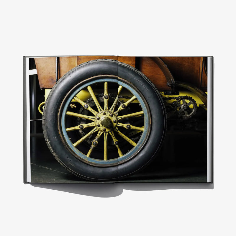 Open book close-up of a car wheel with yellow spokes and black tire