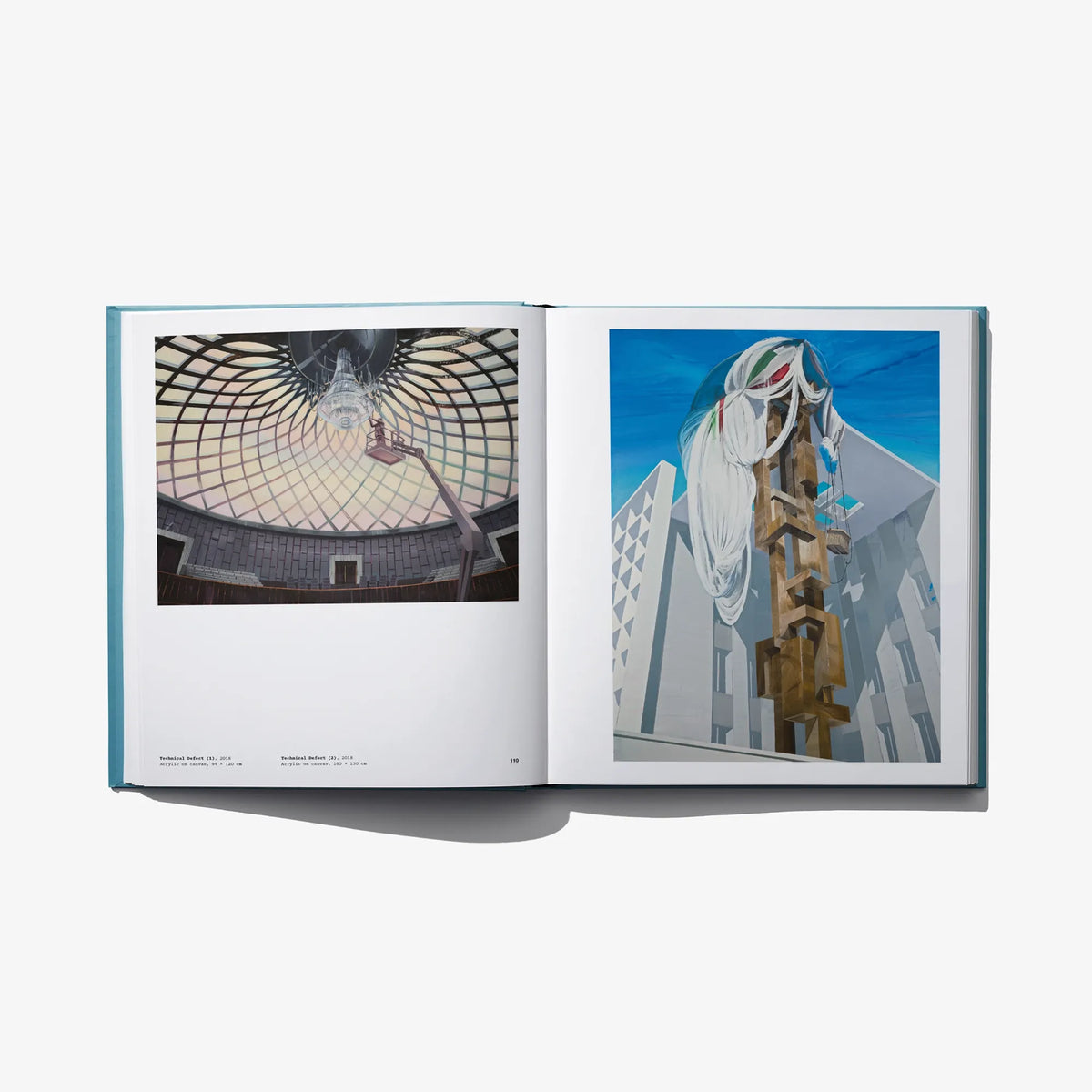 Open art book spread with two architectural photo panels on separate pages