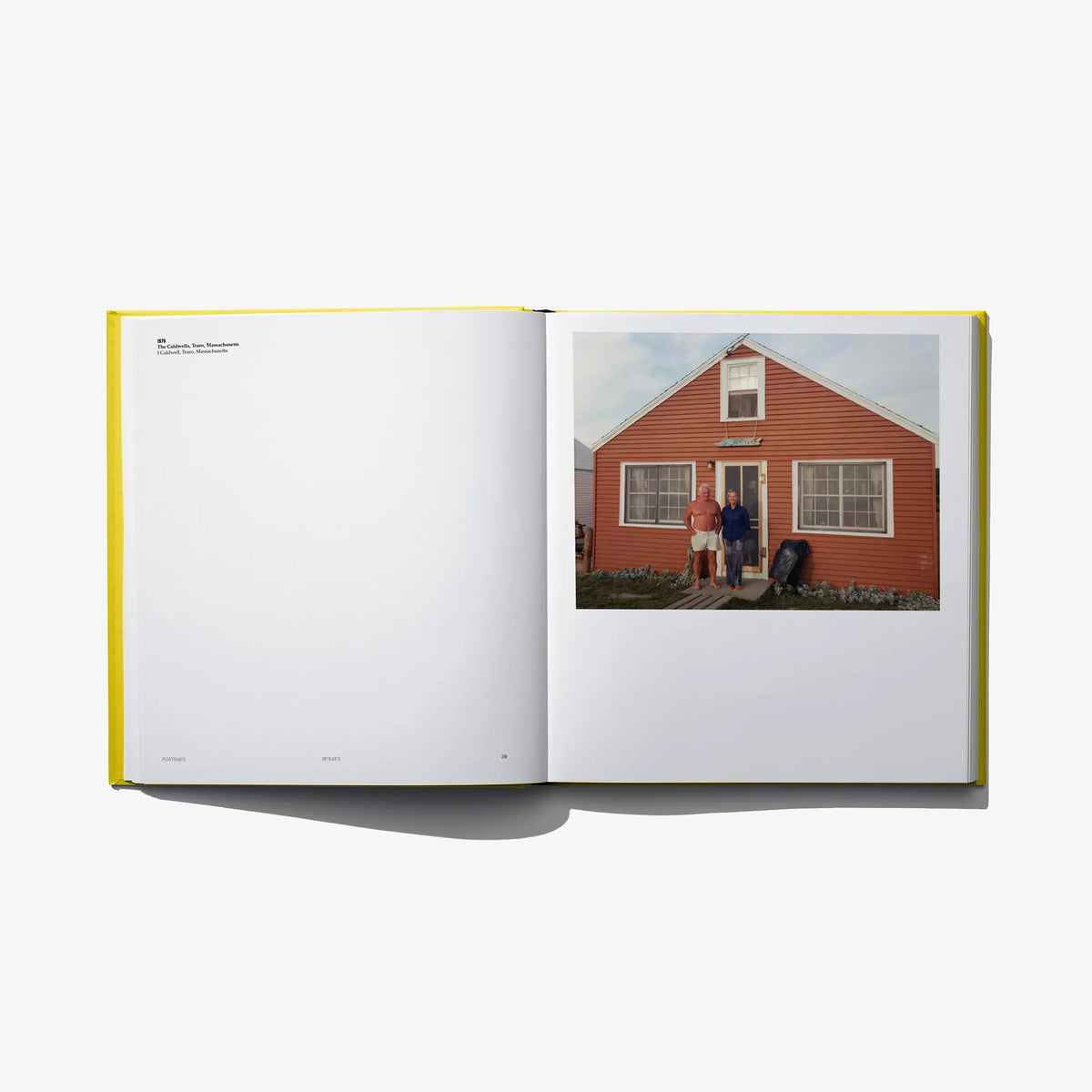 Open photo book spread with a small outdoor house photo on the right page.