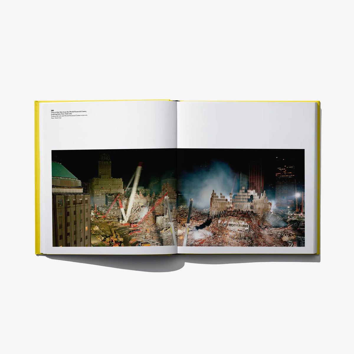 Open photo book spread with a nighttime city scene photo across both pages.