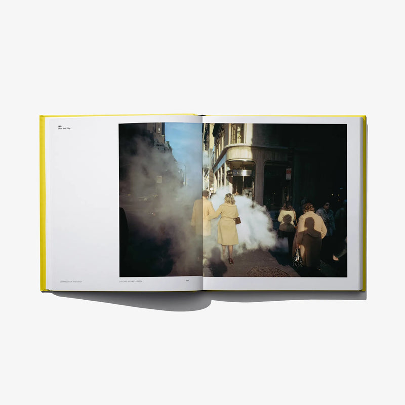 Open photo book spread with a street scene photo featuring people in the right page.