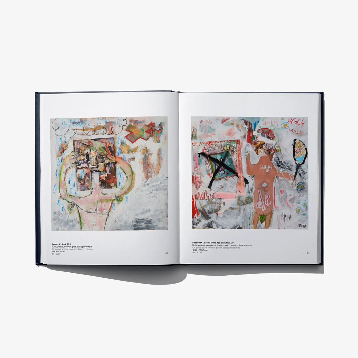 Open art book spread with two colorful abstract head portraits, blue and red accents
