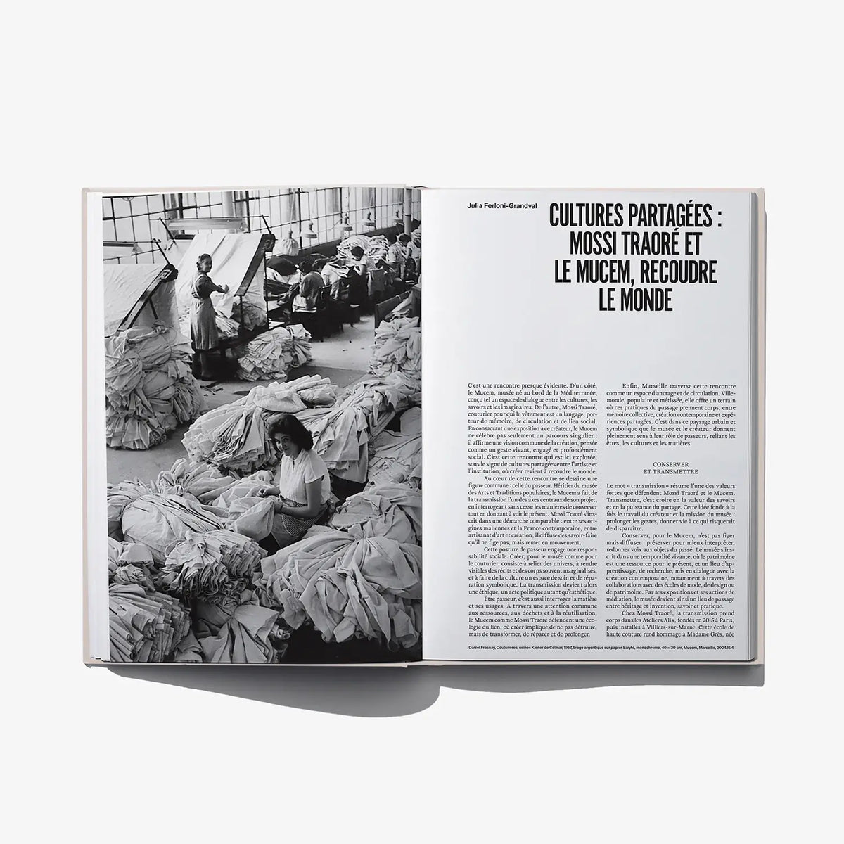 Open fashion book showing a black-and-white editorial photo spread