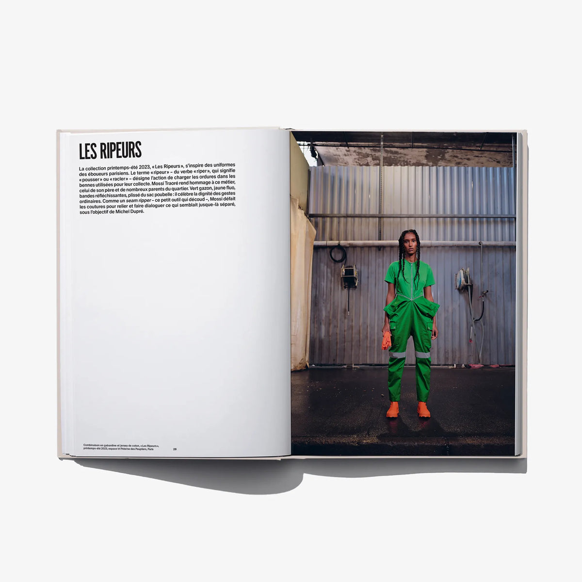 Open fashion book with a model wearing a bright green draped outfit