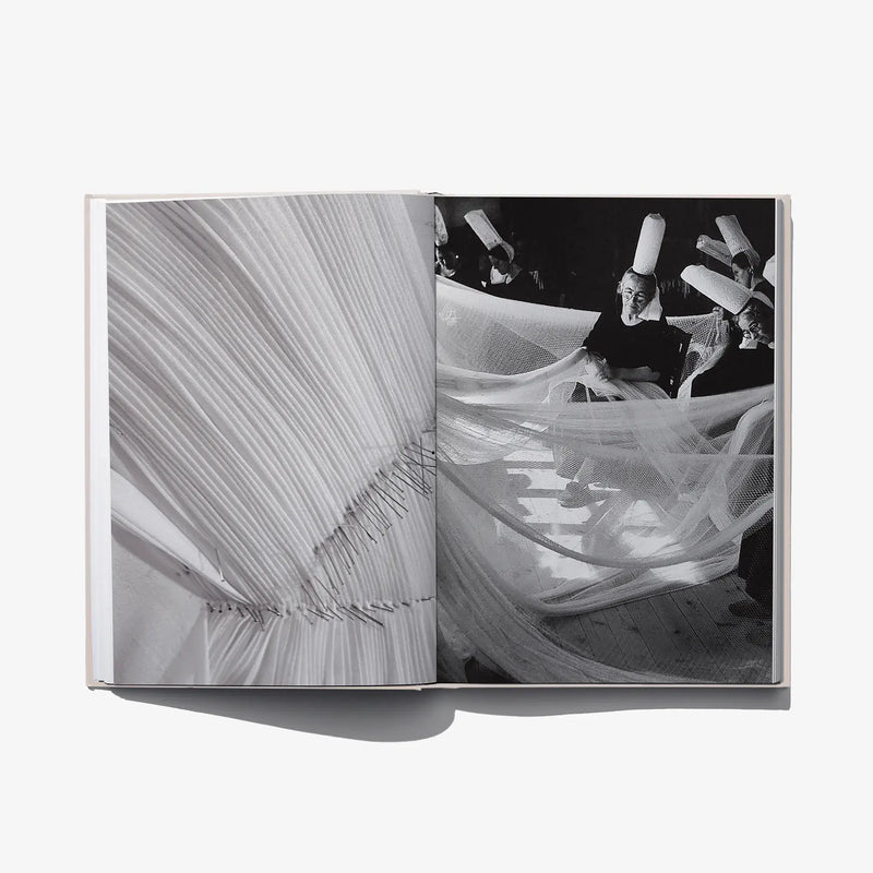 Fashion book close-up spread of flowing draped fabric in black and white