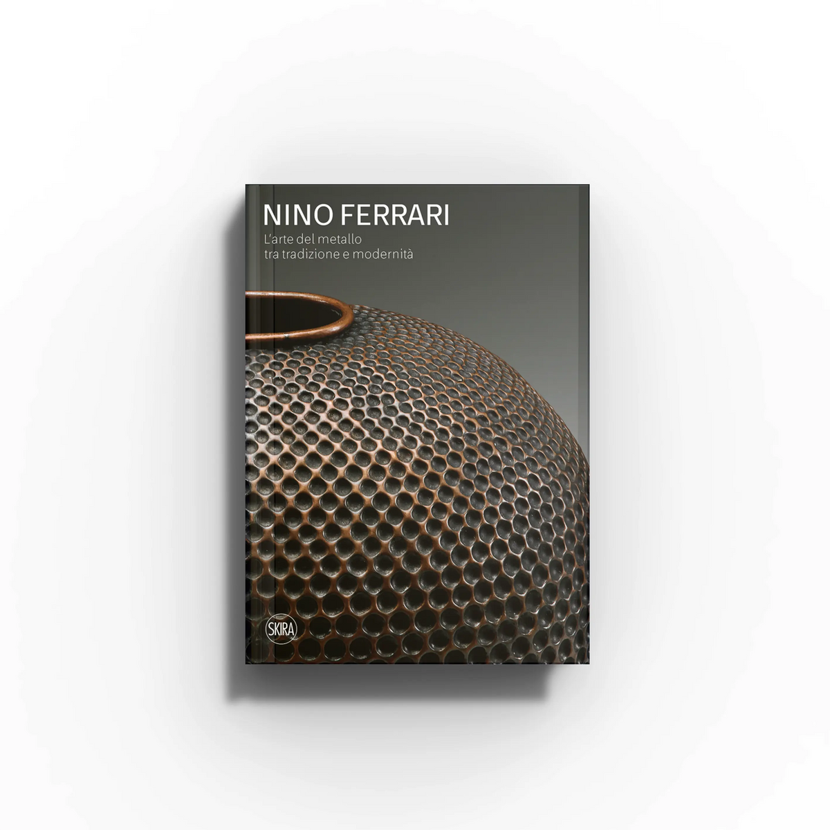 Decorative arts book by Skira Arte, Nino Ferrari, dark cover with metalwork pattern and handle detail