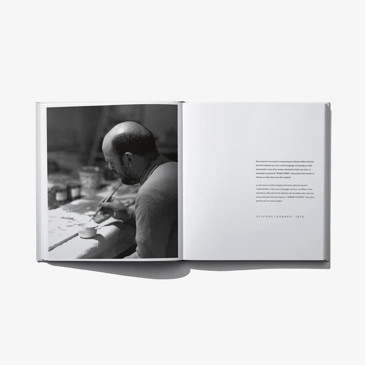 Open book with black-and-white studio photo on left and printed text on right