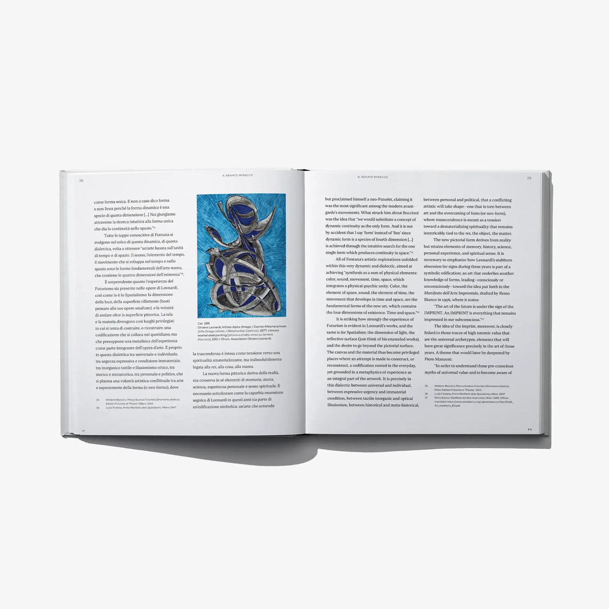 Open book pages with printed text and a small blue abstract enamel artwork thumbnail