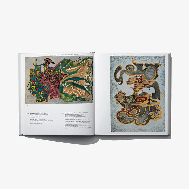 Open book with colorful enamel artwork on left and black-and-gold abstract artwork on right