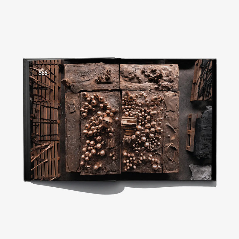 Open sketchbook spread with textured copper relief sketch panels