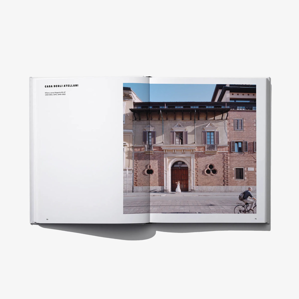 Open hardcover book showing an architectural building photo on the right page.