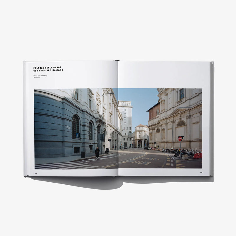 Open hardcover book showing a street view with historic facades on both pages.